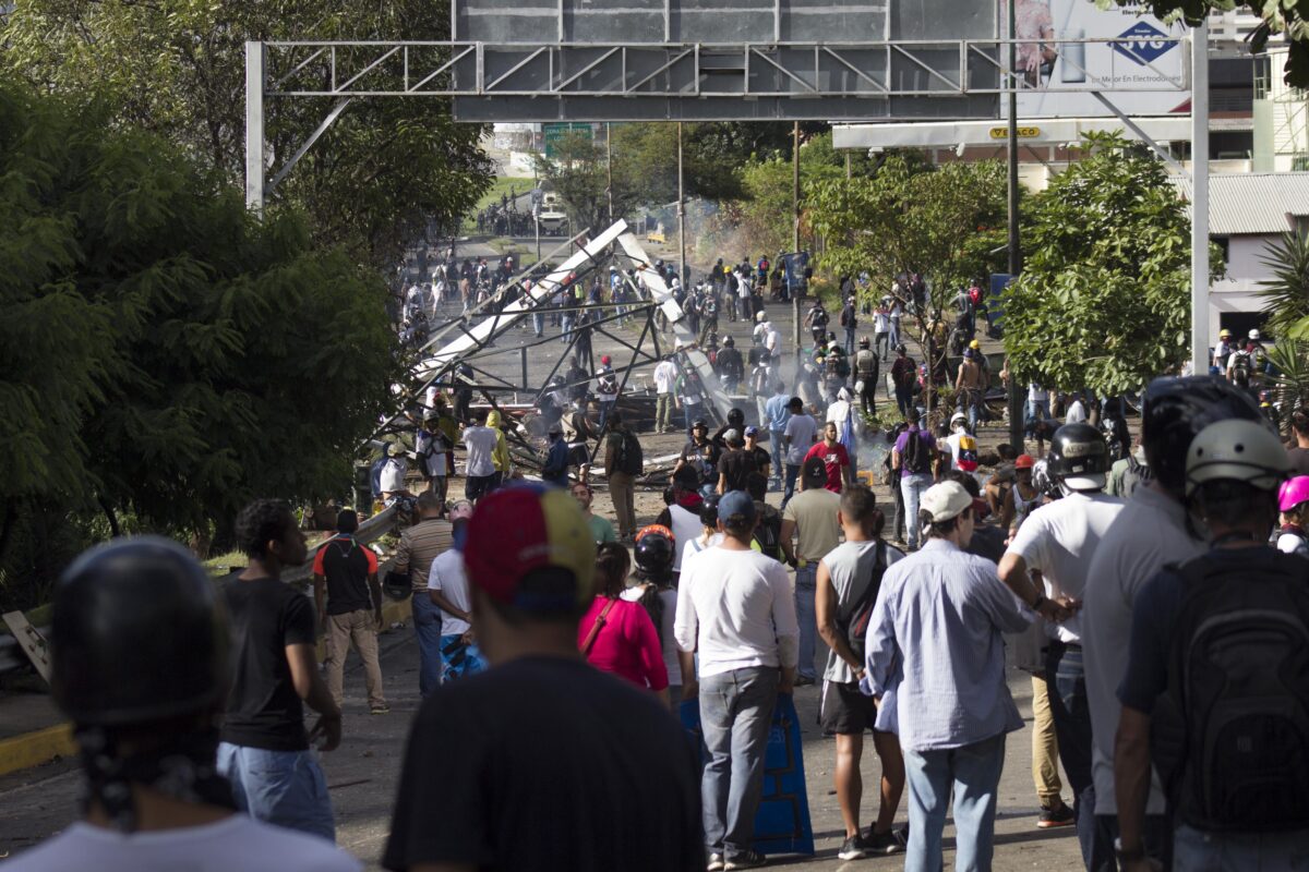 epa06118317 Opposition protesters block a street during a protest held to denounce the the National Constituent Assembly elections, in Caracas, Venezuela, 30 July 2017. Clashes are breaking out as the voting on a constituent assembly takes place under strict security measures and despite the rejection of local opposition and the international community. The new assembly would have powers to rewrite a constitution and bypass the National Assembly which is currently controlled by the opposition. EPA/NATHALIE SAYAGO
